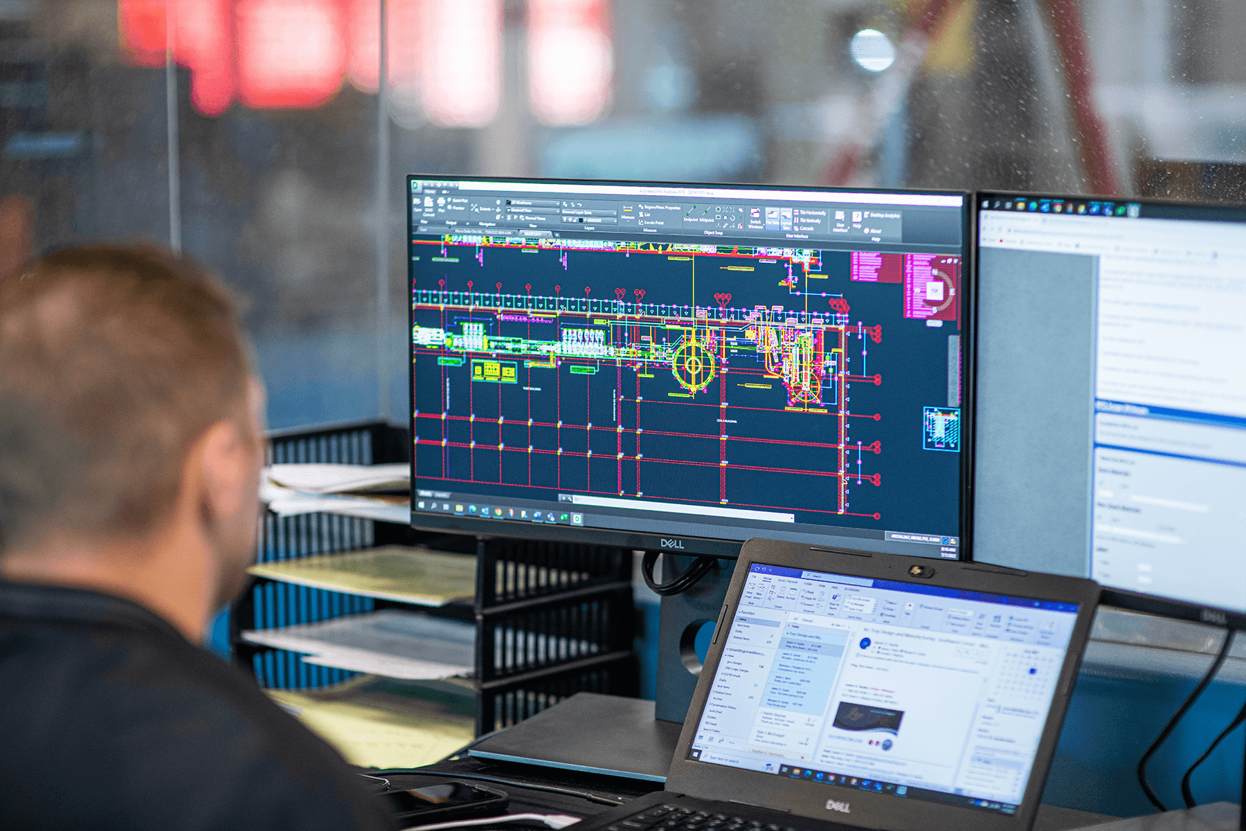 Engineer reviewing infrastructure designs on a monitor
