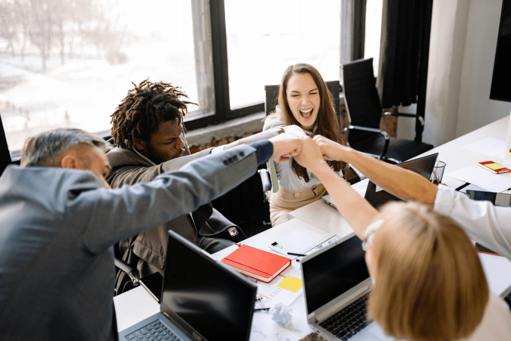Distributed team celebrating a launch together at the desk